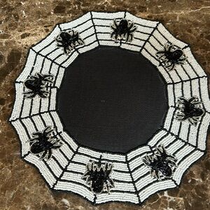 A set of four Tahari Home Halloween beaded chargers.